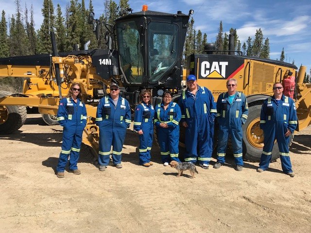Top Notch Oilfield Contracting crew on site with a Cat 14M motor grader